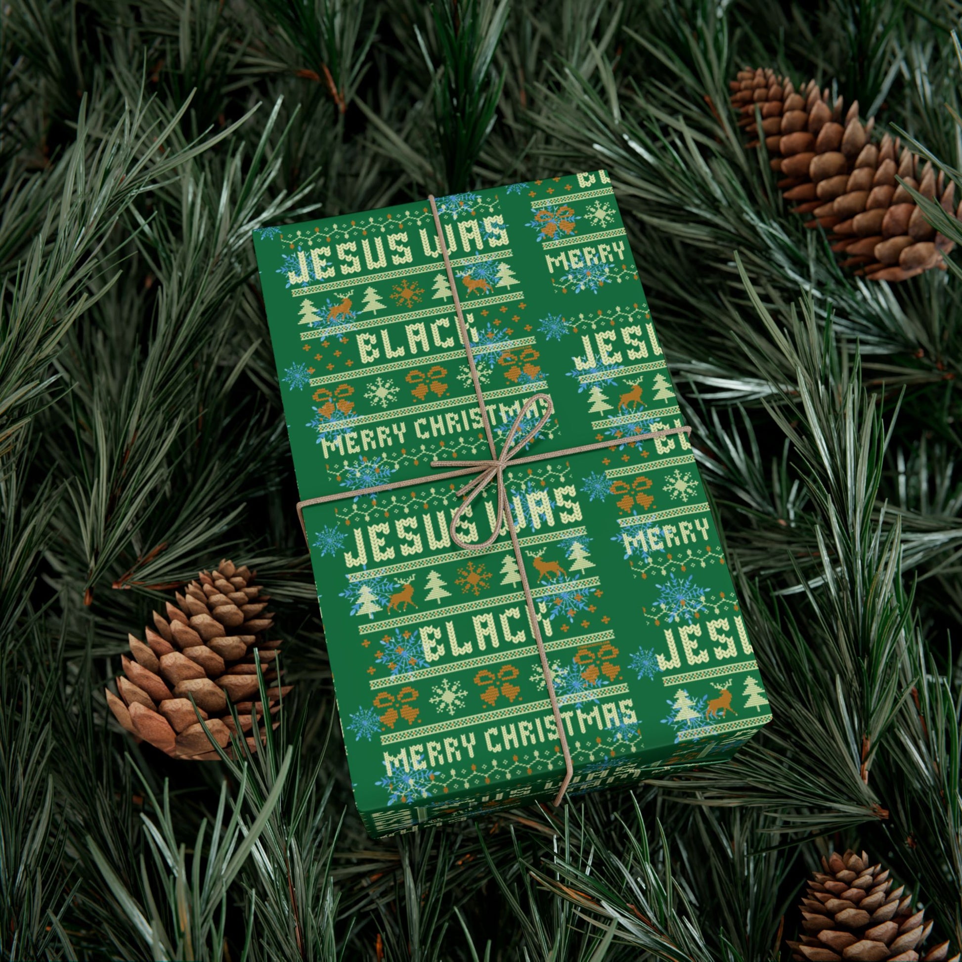Festive Jesus Was Black Merry Christmas green wrapping paper wrapped around a gift nestled in pine branches, perfect for seasonal gift giving.