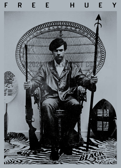 a black and white photo of a huey p newton sitting in a wicker chair
