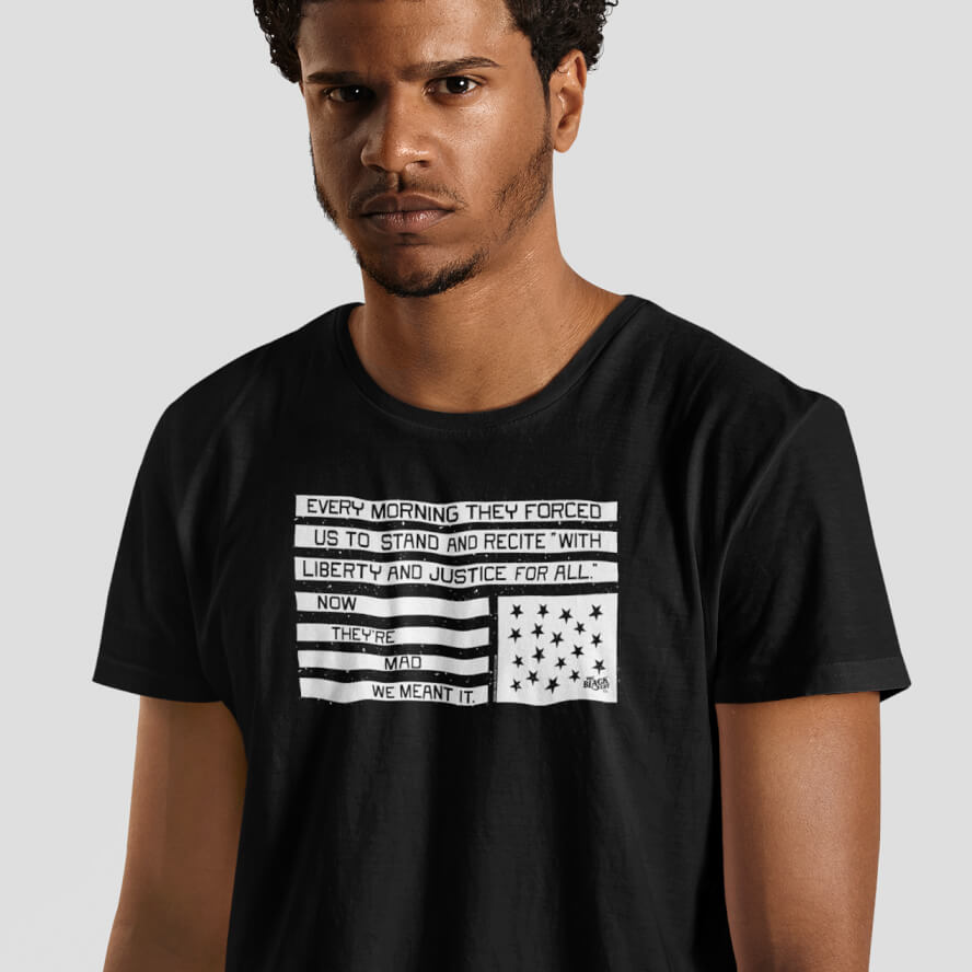 Model wearing black graphic t-shirt with pledge of allegiance liberty and justice protest message