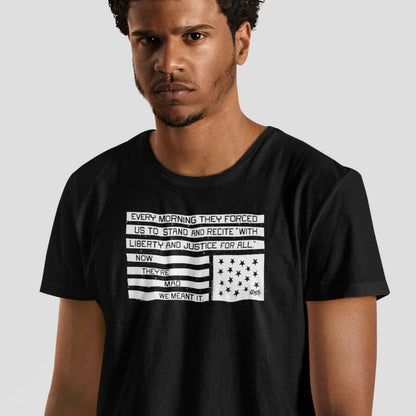 Model wearing black graphic t-shirt with pledge of allegiance liberty and justice protest message