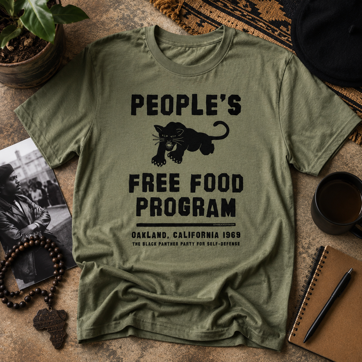 Military green t-shirt with Black panther party graphic over a boho background