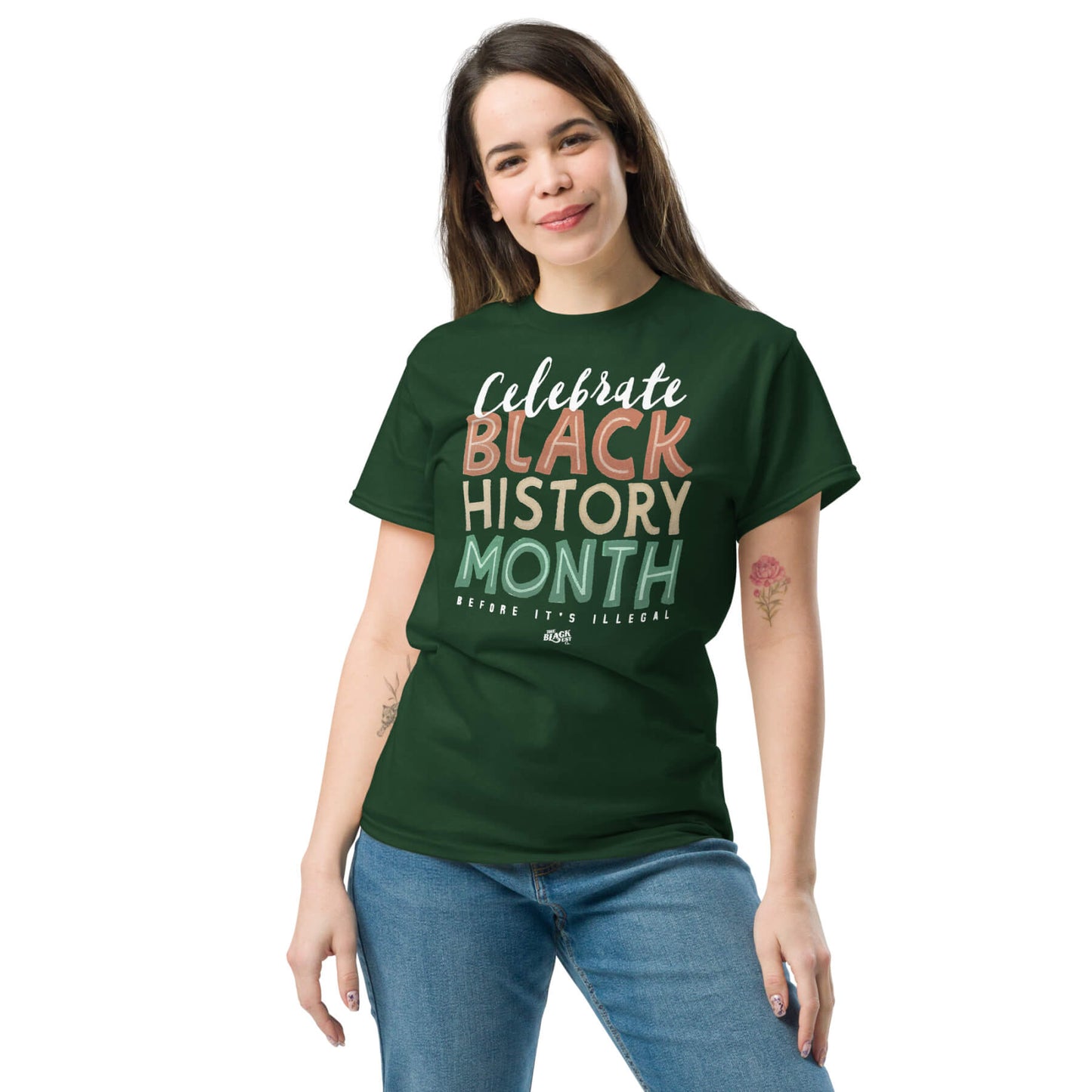 Woman wearing a green 'Celebrate Black History Month Before It's Illegal' t-shirt. Casual and trendy graphic tee for Black History Month.