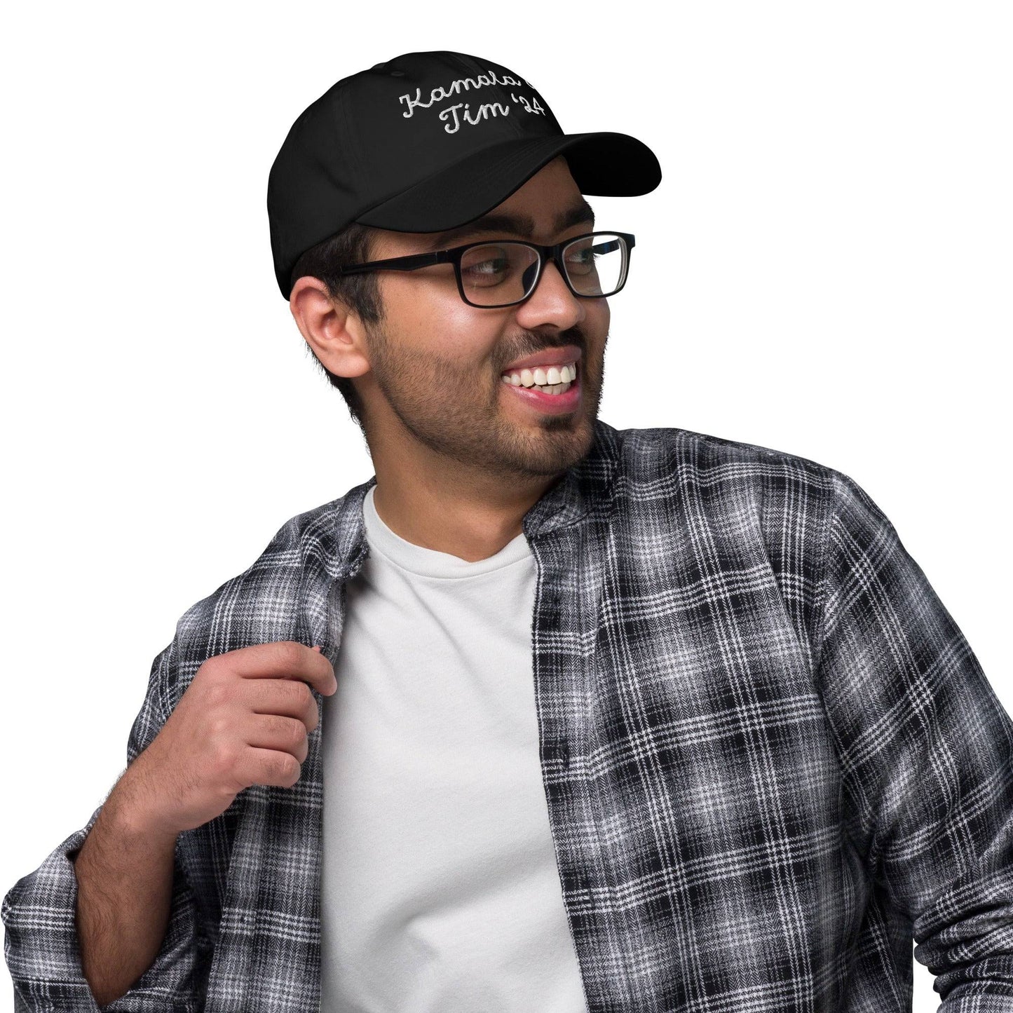 Smiling person in glasses wearing Kamala & Tim '24 cap