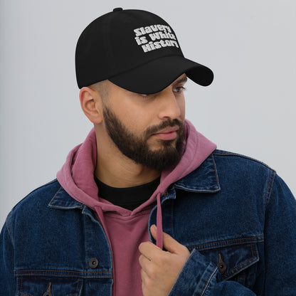 Man in denim jacket and hoodie wearing Slavery Is White History Embroidered Dad Hat by TheBlacket Co., styled for everyday streetwear.
