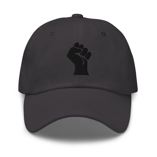 Black On Black Power Fist Embroidered Baseball Cap featuring a bold black fist symbol on a low-profile unstructured cotton twill hat.