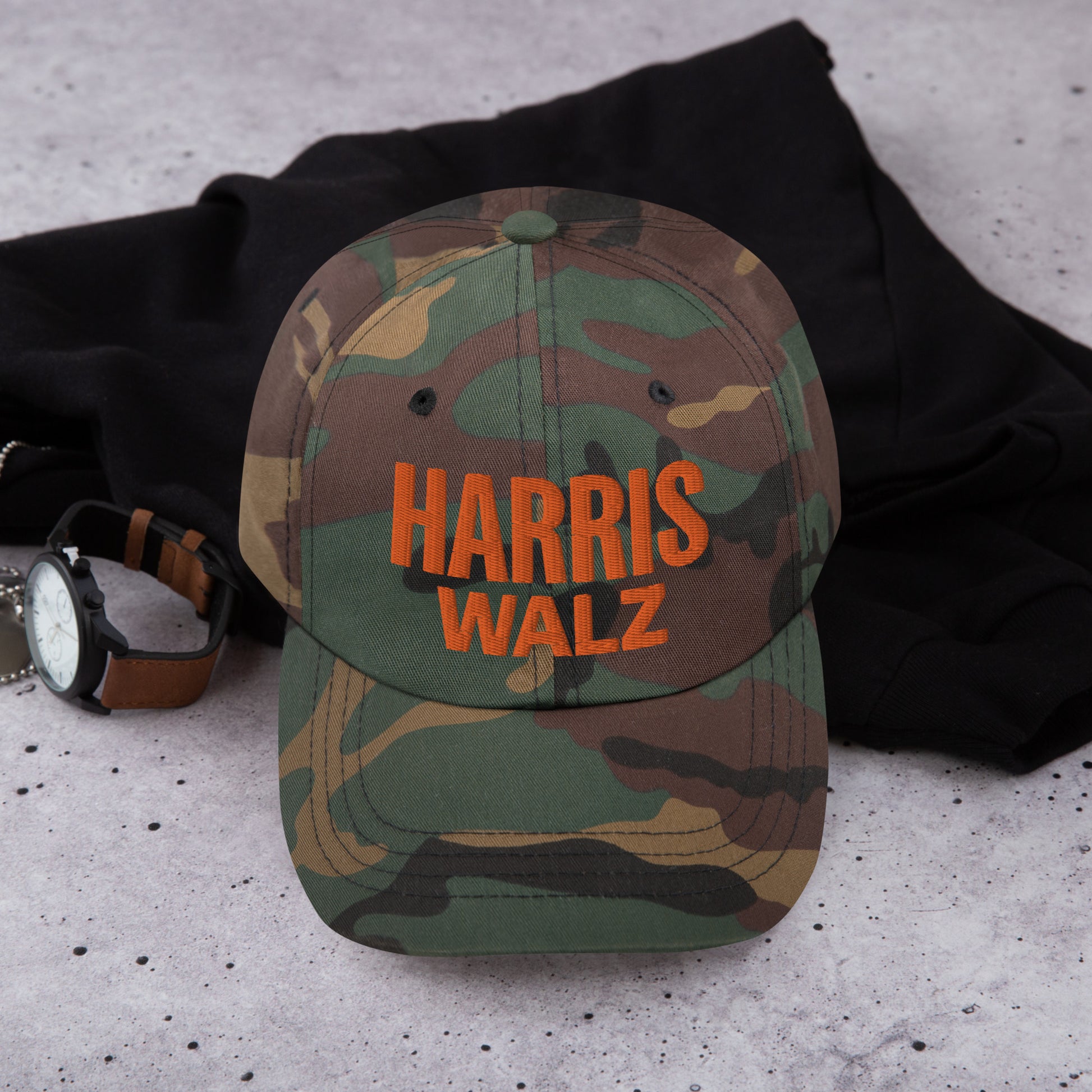 Harris Walz camo hat on table with watch