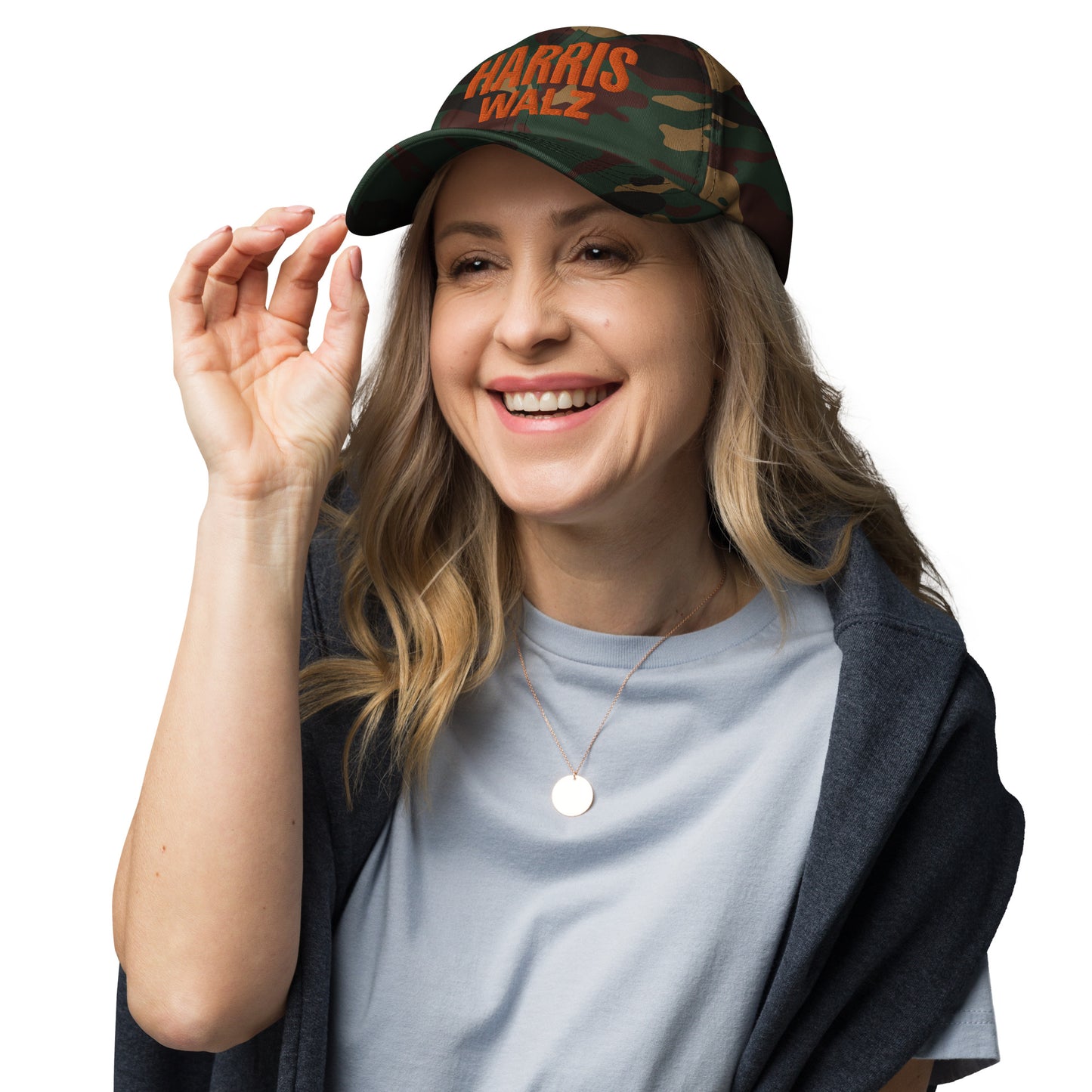 Smiling woman wearing Harris Walz camo hat