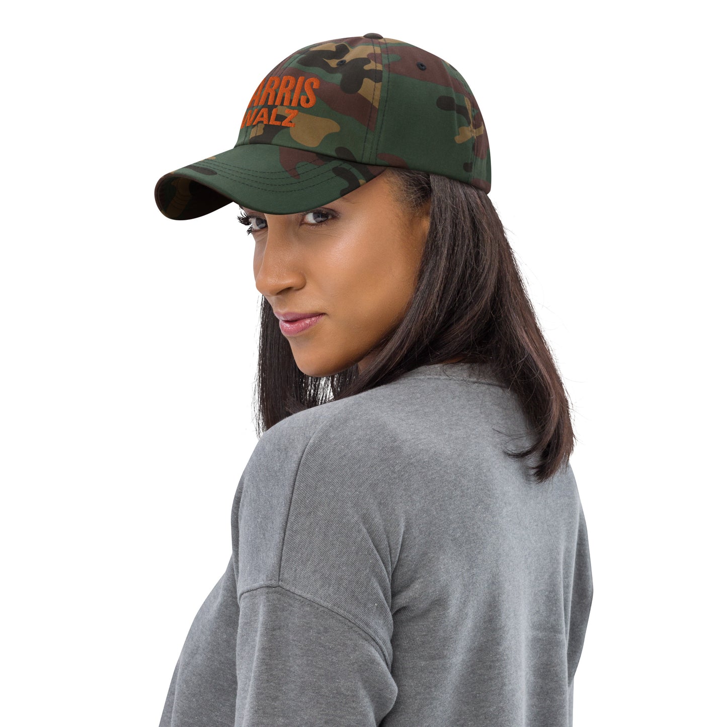 Woman wearing Harris Walz camo hat, side view