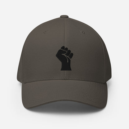 Dark gray Flexfit structured cap with black embroidered power fist, designed by TheBlackest Co. for cultural expression and sleek fit.