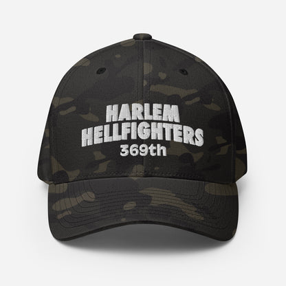 Front view of 369th Harlem Hellfighters Flexfit® Cap in black camo with bold white embroidery. Athletic fit with curved visor for modern style.