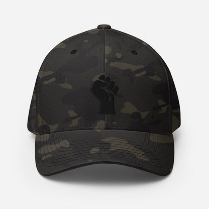 Black camo Flexfit structured cap with tonal black embroidered power fist, blending urban style and cultural identity by TheBlackest Co.