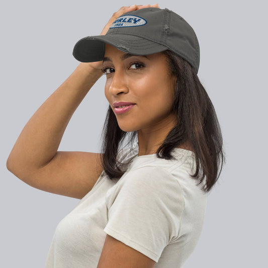 a woman wearing a gray hat with Gurley on it and white shirt