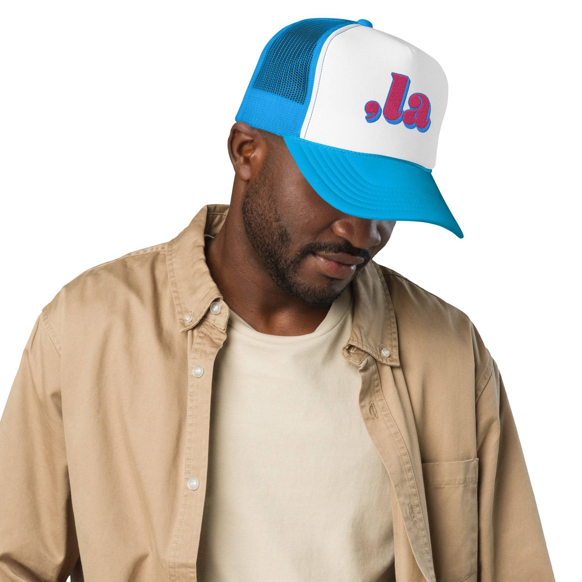 Man wearing blue Retro Kamala embroidered trucker hat