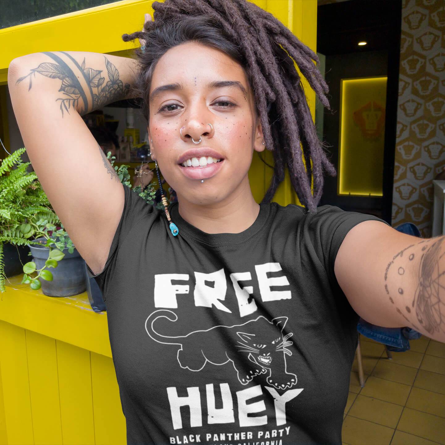 black girl with dreadlocks wearing a free huey t shirt by theblackestco