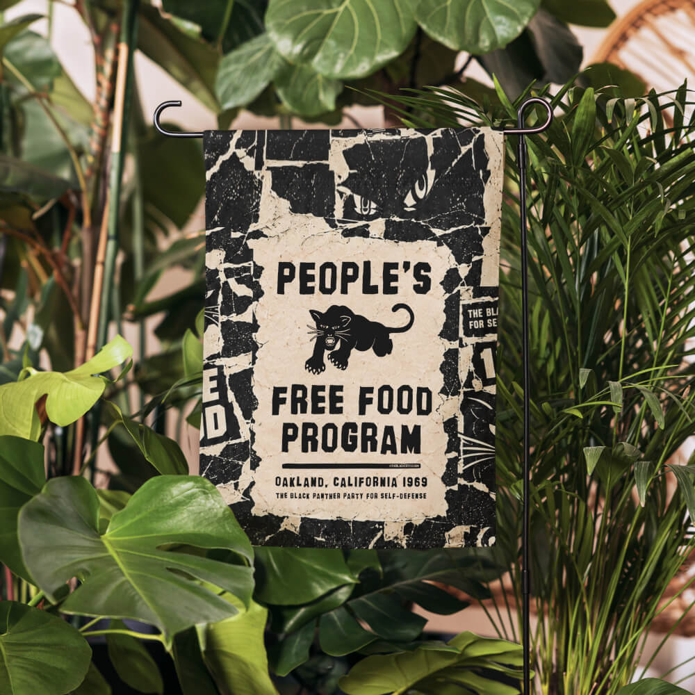 People's Free Food Program garden flag with the Black Panther Party panther logo on a stand among green houseplants