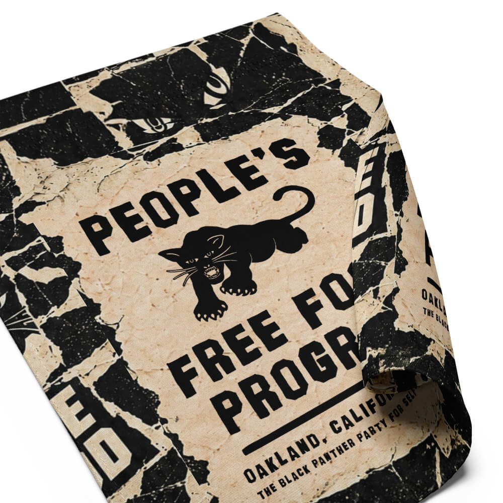 Close-up of the Black Panther Party panther logo and People's Free Food Program lettering on the garden flag