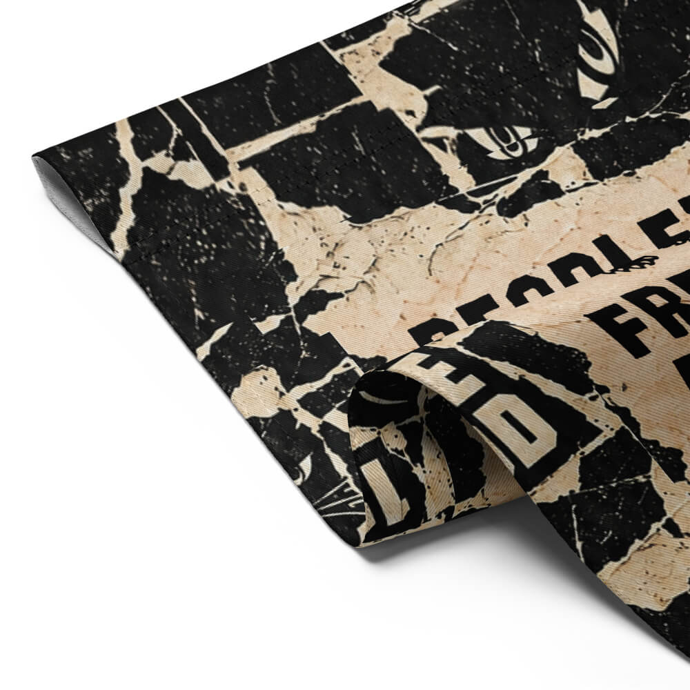 Close-up of the folded corner of the People's Free Food Program garden flag showing the print and stitched edge