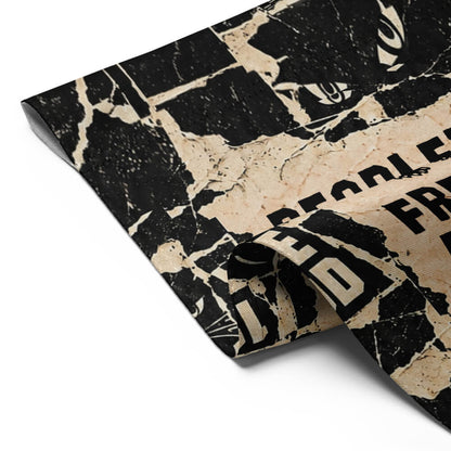 Close-up of the folded corner of the People's Free Food Program garden flag showing the print and stitched edge