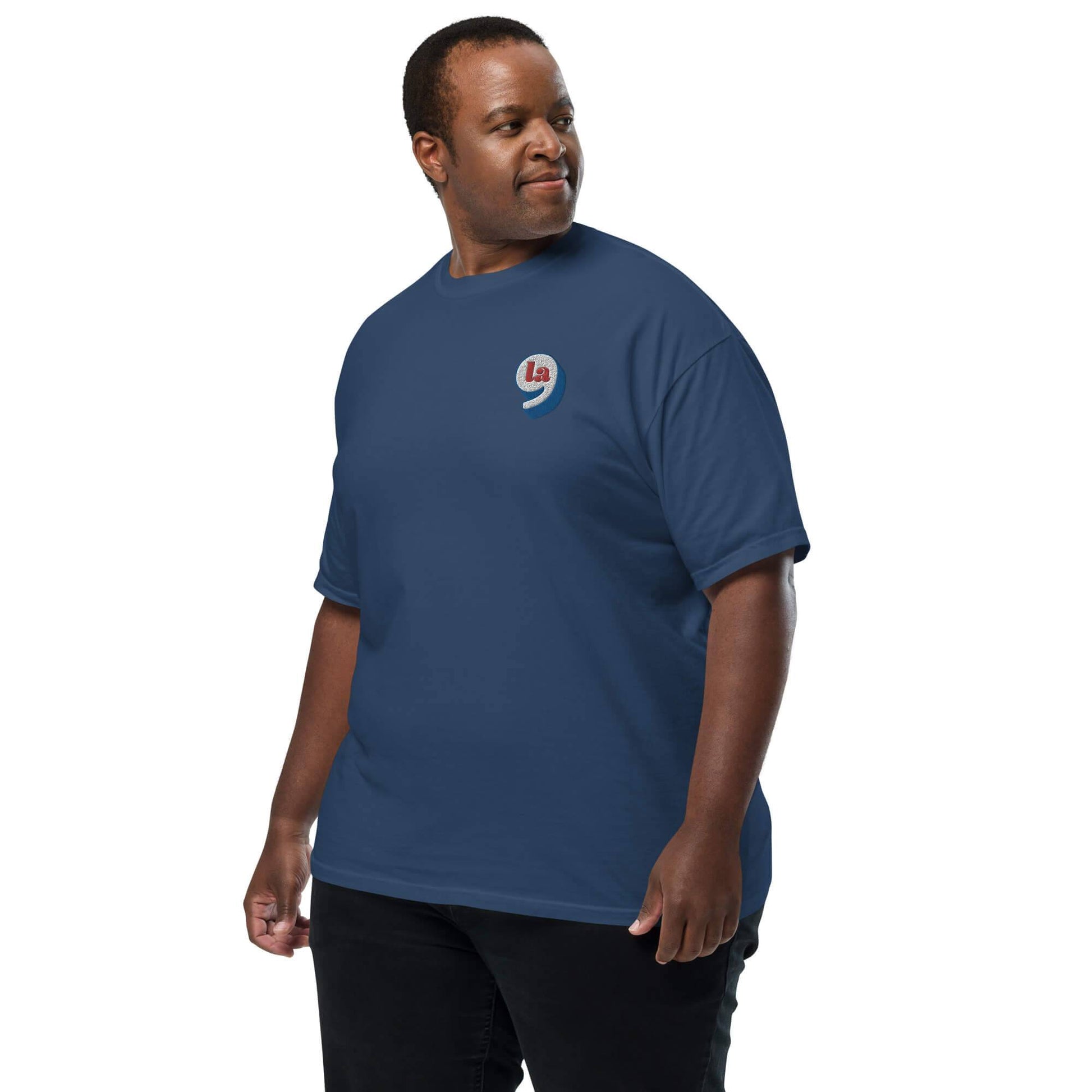 Man wearing navy blue t-shirt with red white blue embroidery