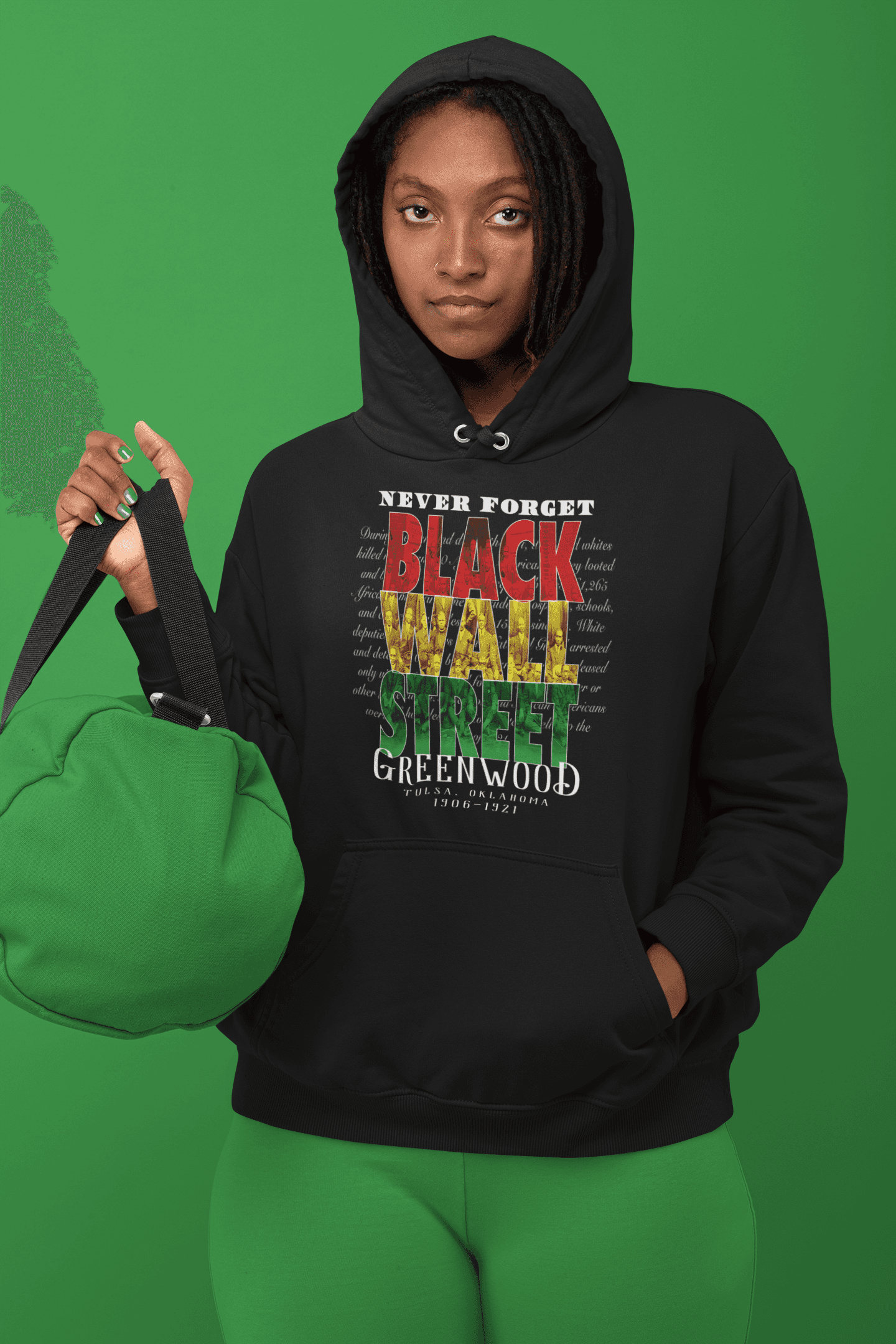 woman in a hoodie with black history design holding a bag monochromatic green scene