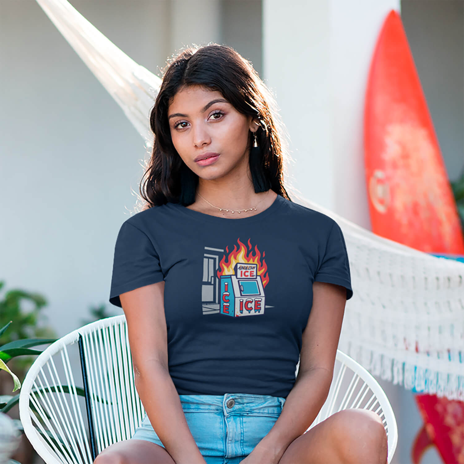 Model wearing navy Abolish ICE Women’s Softstyle T-Shirt by TheBlackest Co., styled casually with denim shorts for a relaxed protest-ready look.