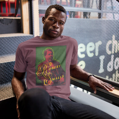 Man wearing a t-shirt with a graphic design of Robert Smalls sitting on the stairs of a bookstore.