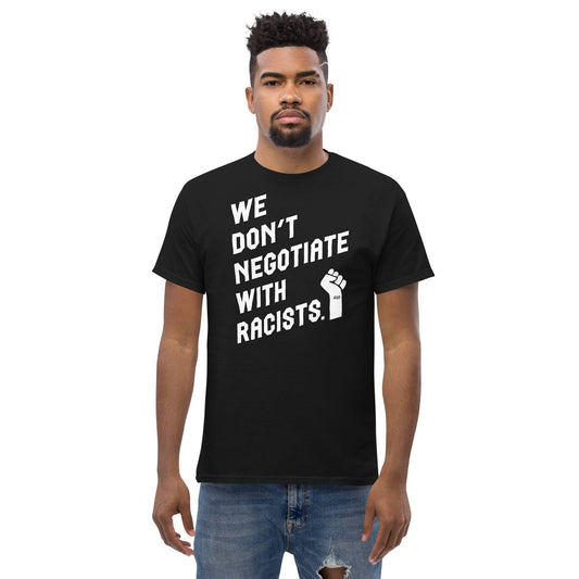 man wearing a black t shirt with white lettering reading we don't negotiate with racists