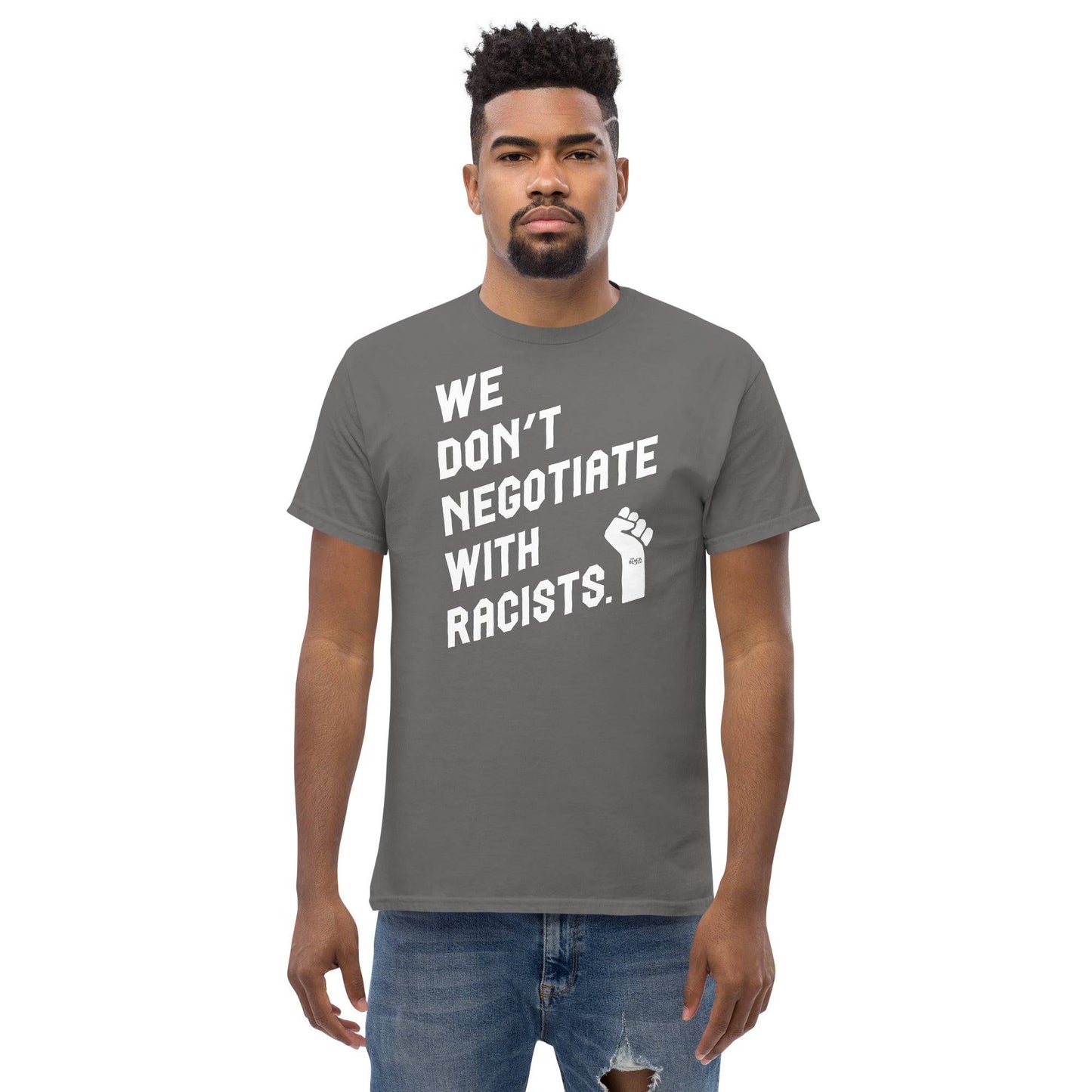 man wearing a medium gray t shirt with white lettering reading we don't negotiate with racists