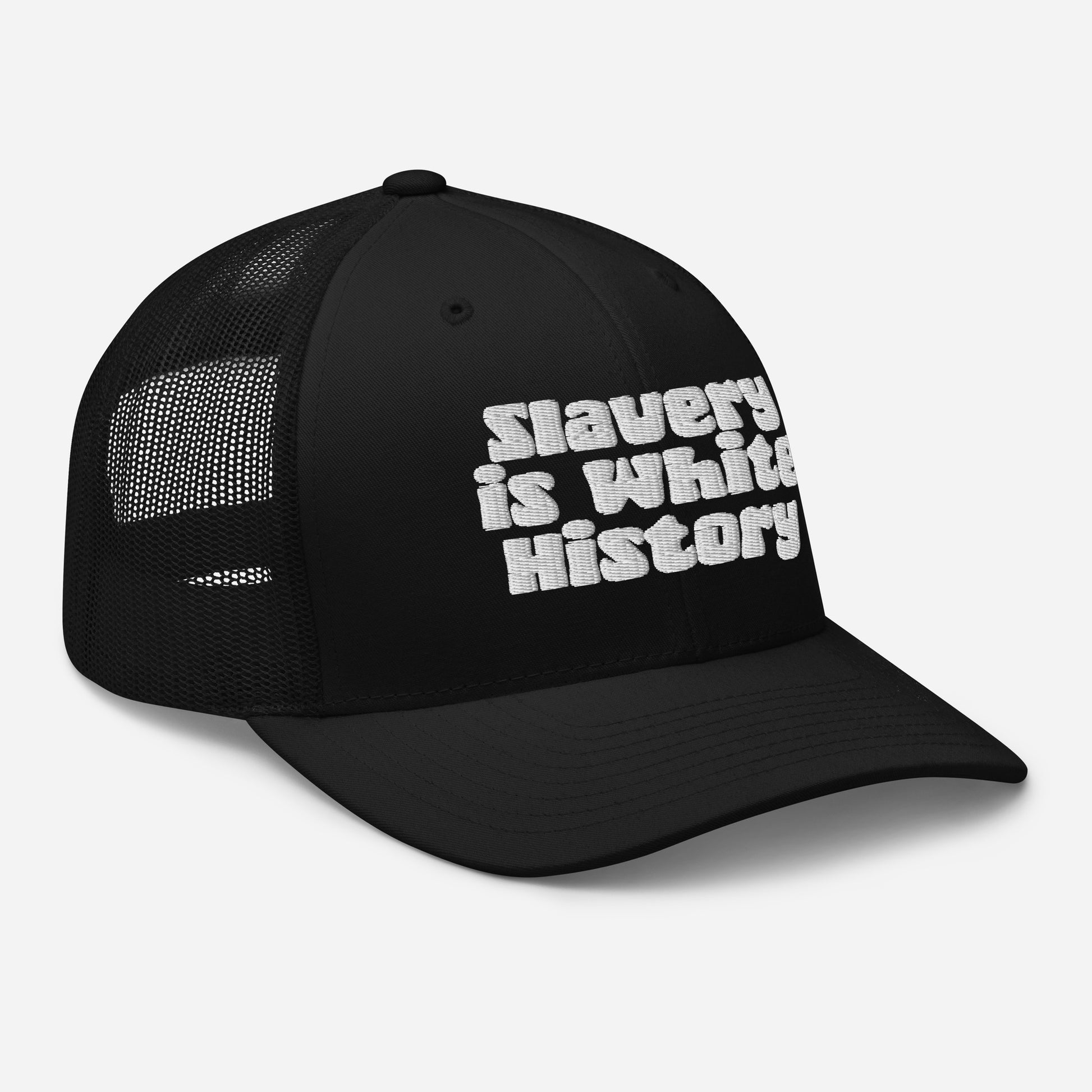 Left side view of Slavery Is White History Trucker Hat by TheBlackest Co., black color with white embroidered text and mesh back.