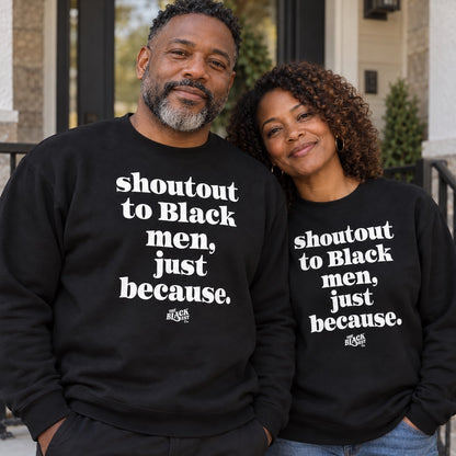 Close-up of the black sweatshirt worn by a smiling man and woman, featuring the printed message supporting Black men, casual style.