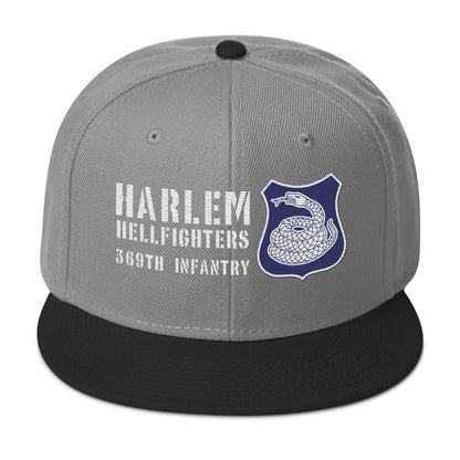 a gray and black hat with a white and purple rattlesnake crest on it with text that reads harlem hellfighters 369th infantry regiment