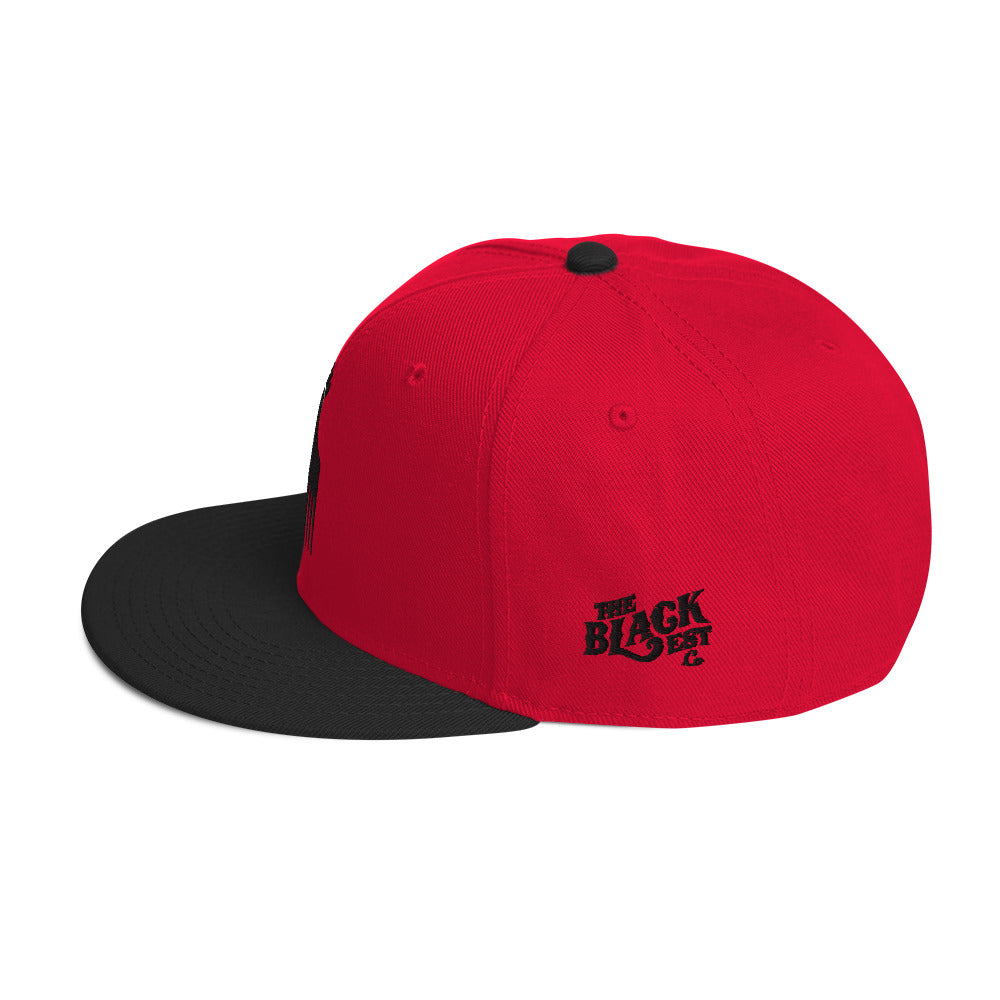 red and black snapback hat with raised fist pick and blackest co logo embroidery