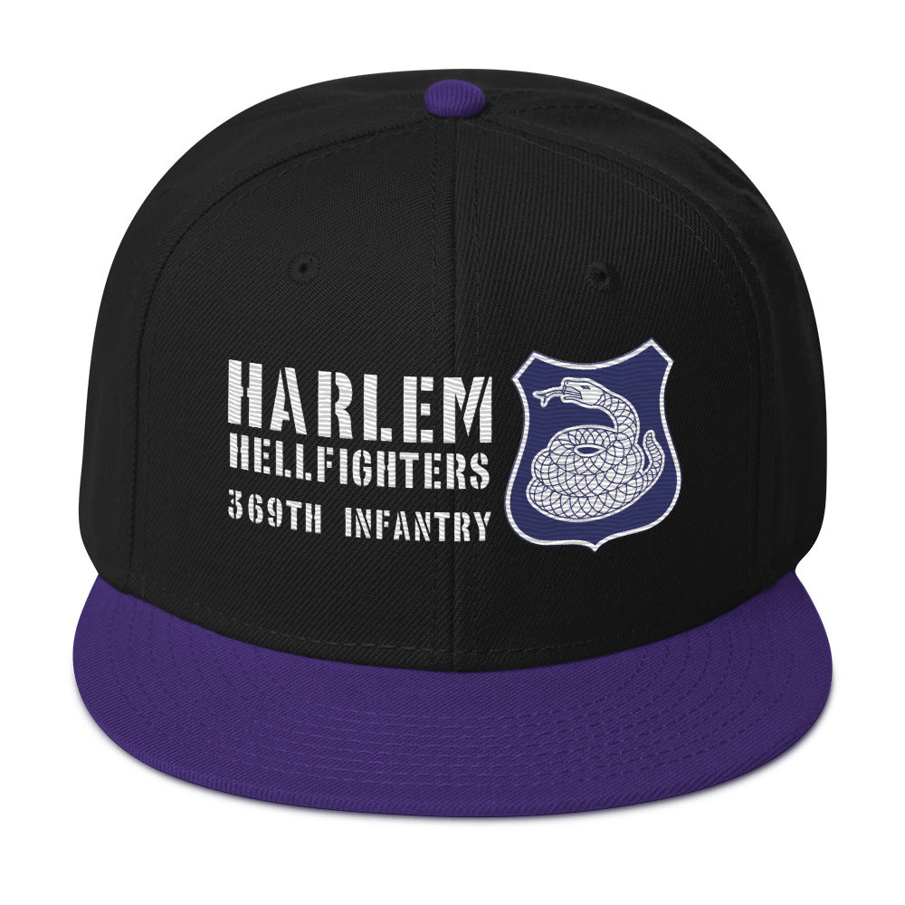a black and purple hat with a white and purple rattlesnake crest on it with text that reads harlem hellfighters 369th infantry regiment