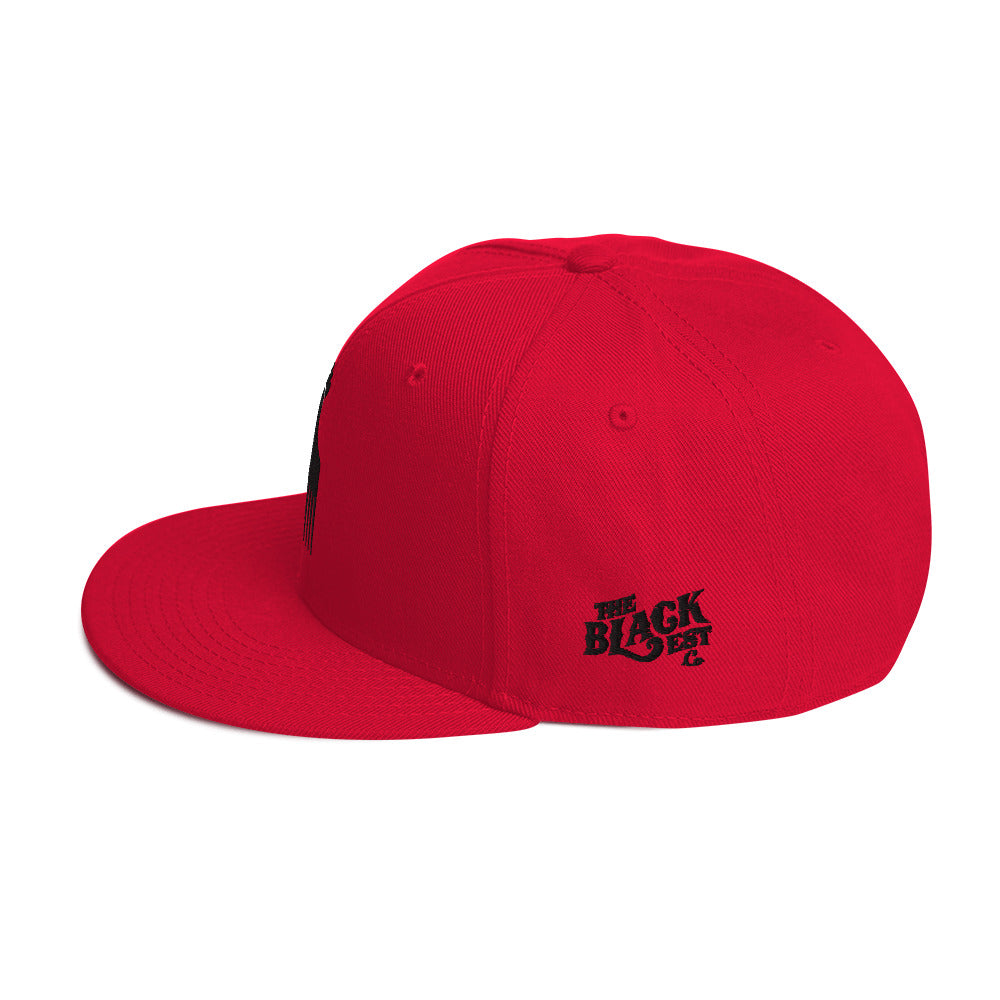 red snapback hat with raised fist pick and blackest co logo embroidery