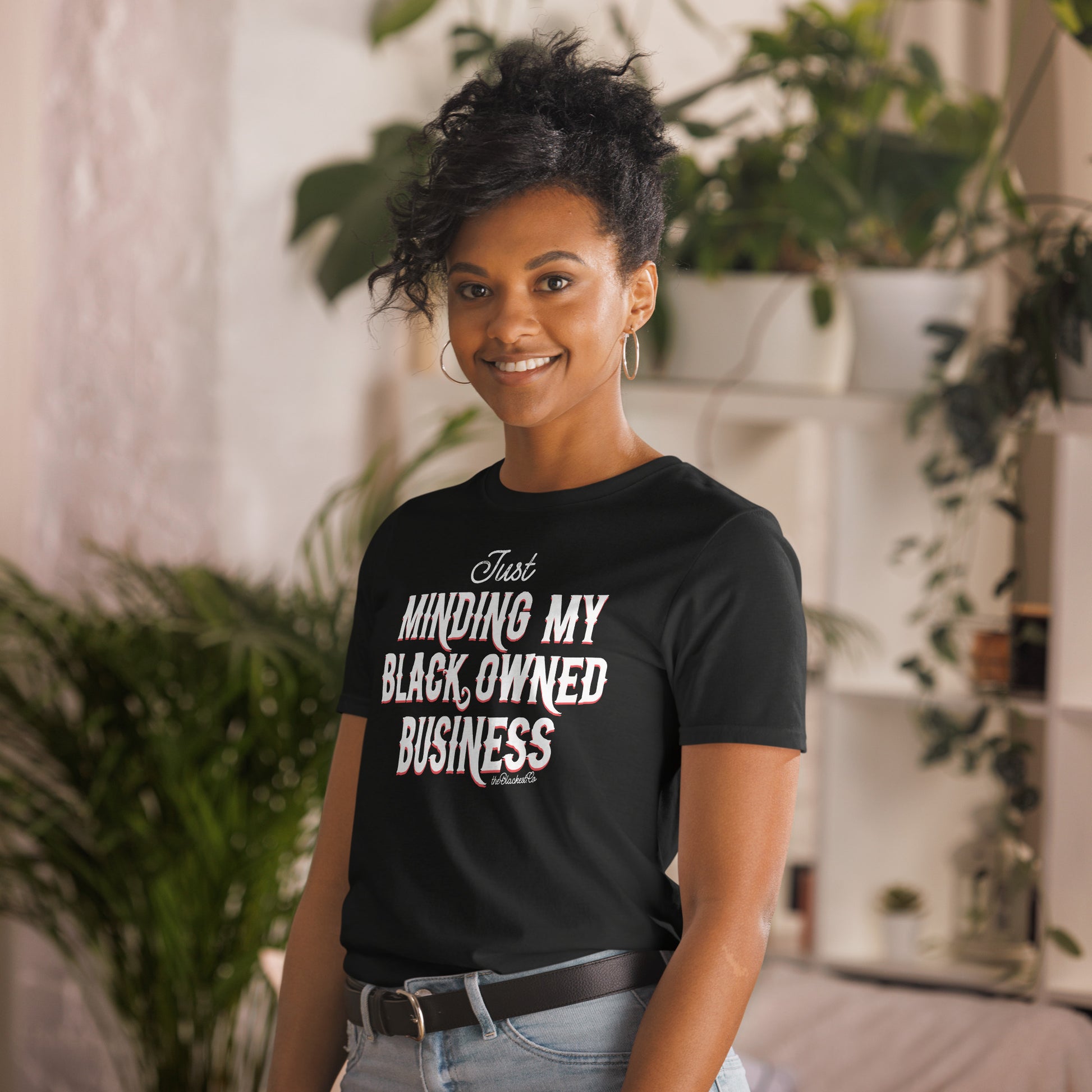 woman wearing black t shirt with Just Minding My Black Owned Businesses design on it
