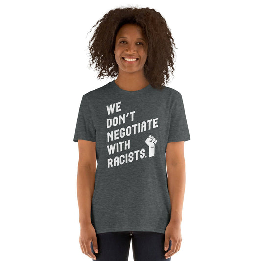woman wearing dark heather t shirt with white text reading we don't negotiate with racists