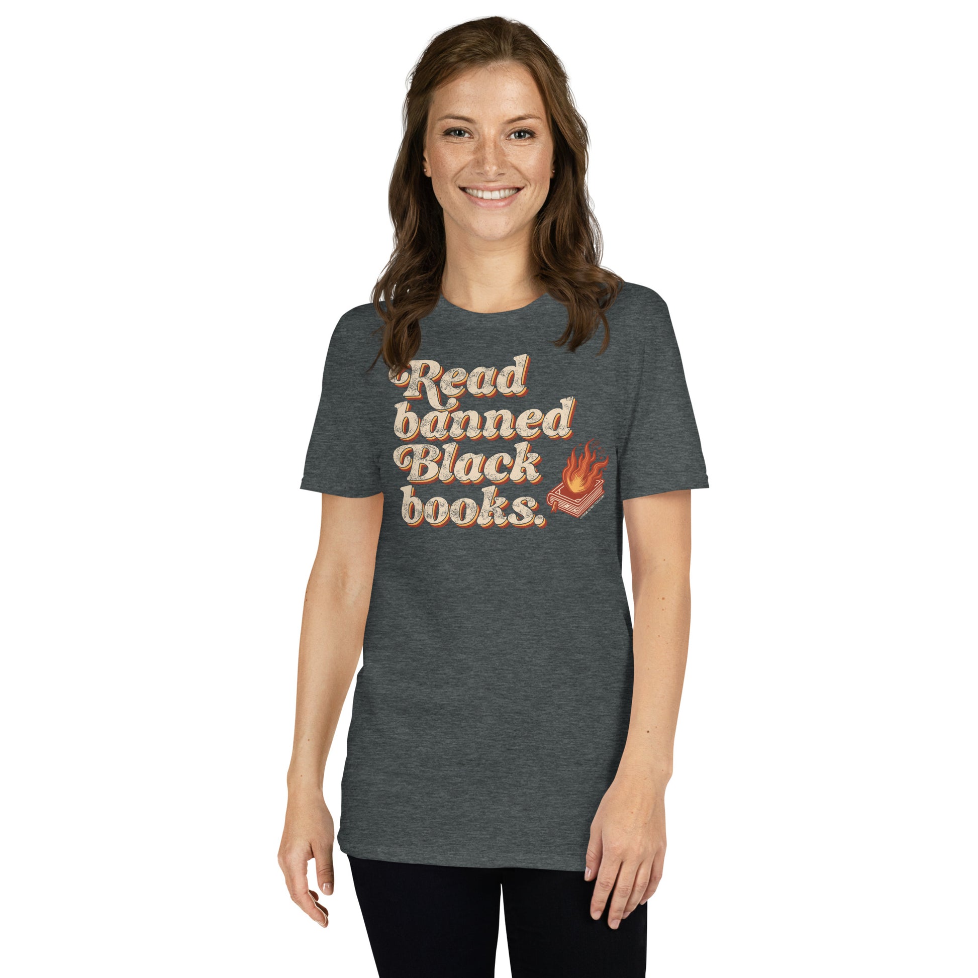 Smiling woman in a dark gray 'Read Banned Black Books' t-shirt with a flaming book graphic, styled simply with black leggings.