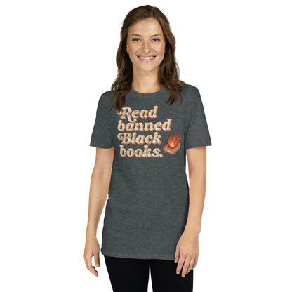 Smiling woman in a dark gray 'Read Banned Black Books' t-shirt with a flaming book graphic, styled simply with black leggings.