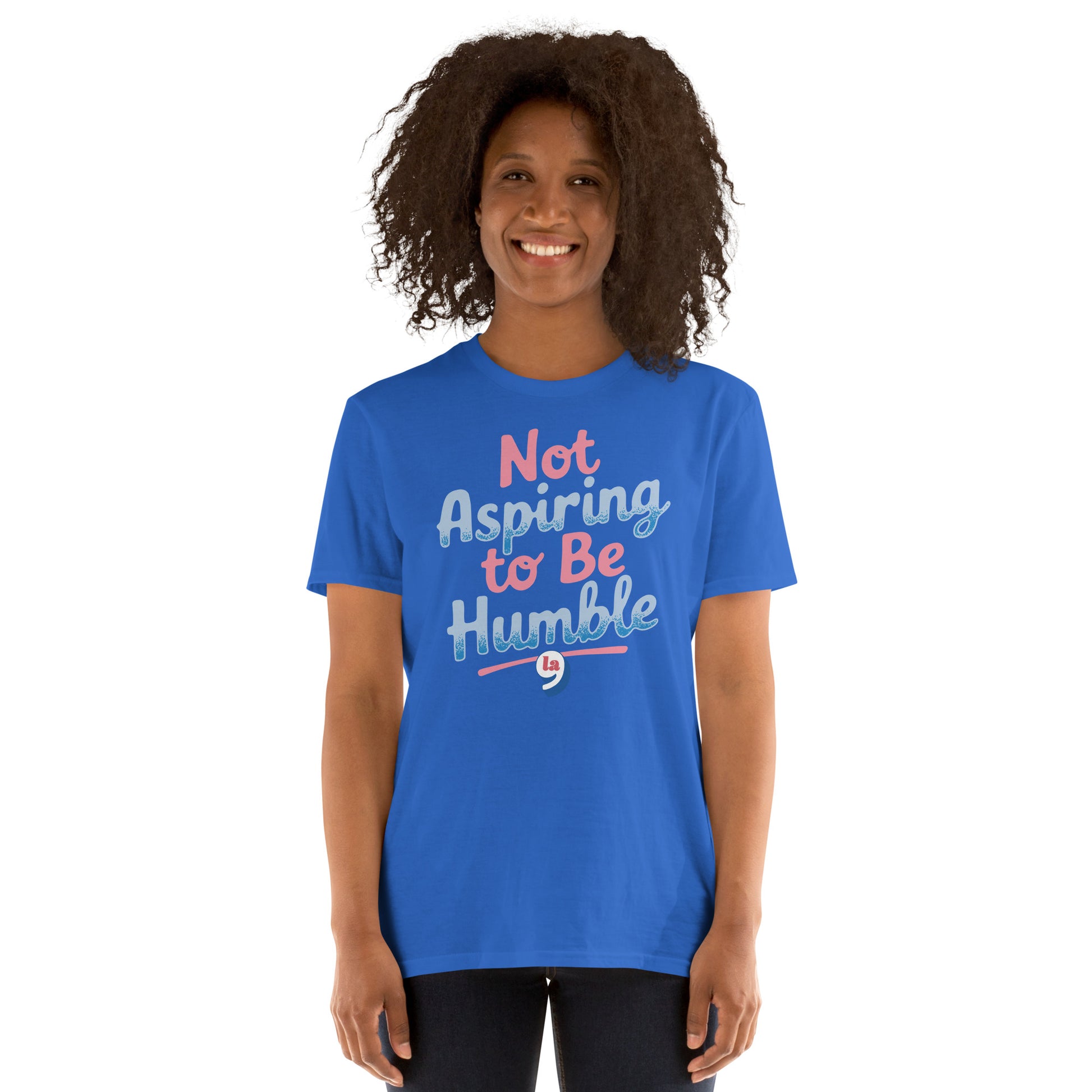 Front view of woman in blue 'Not Aspiring to Be Humble' tee