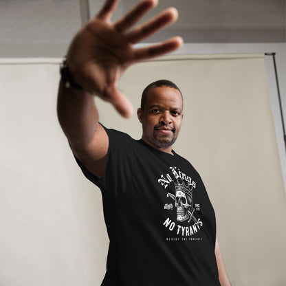 Man posing in No Kings No Tyrants Skull Protest T-Shirt by TheBlackest Co., black activist tee with bold skull and crown design, resistance fashion.