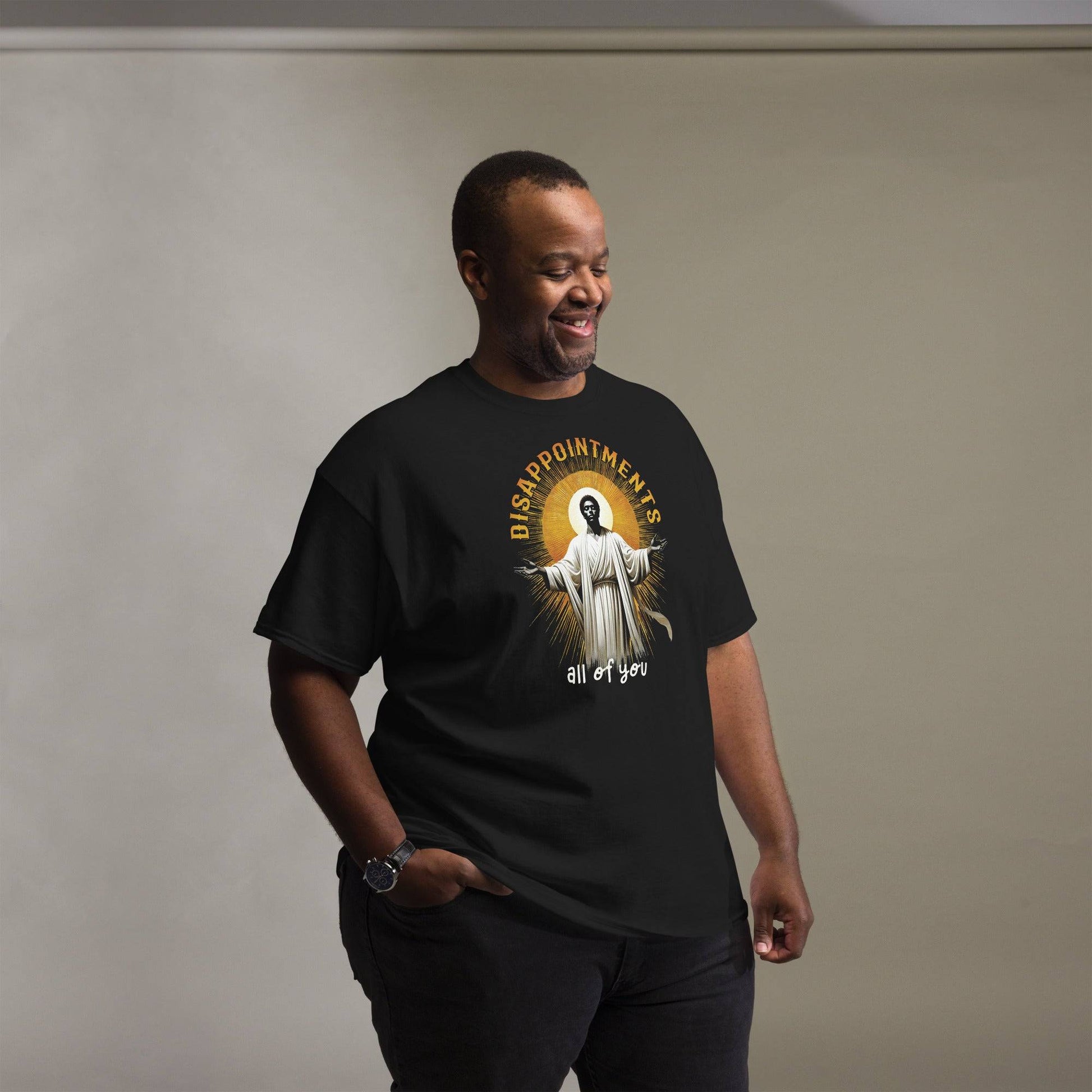 Man wearing Disappointments All Of You Black Jesus T-Shirt in black, showcasing bold cultural graphic and relaxed fit for streetwear style.