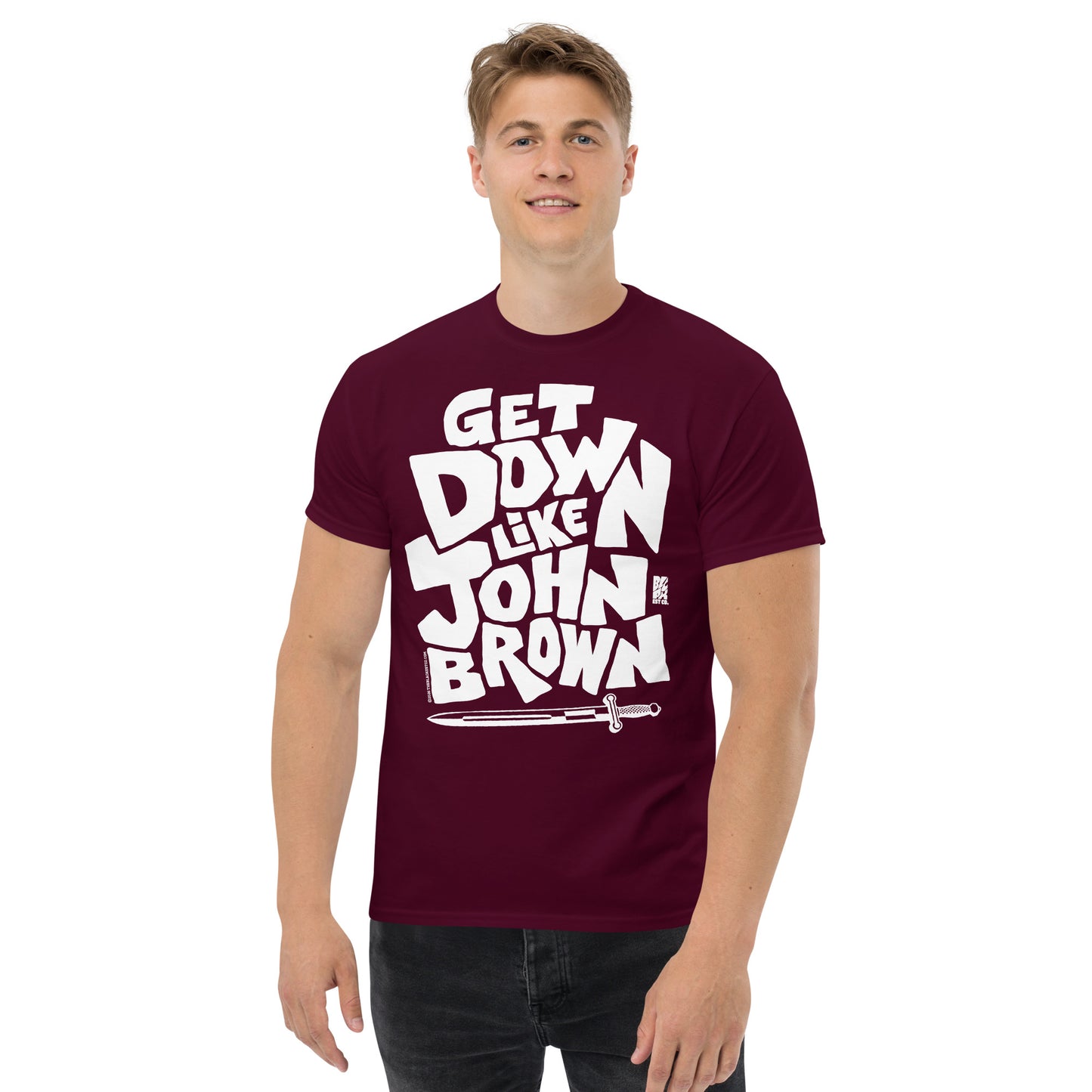 Unisex graphic T-shirt in burgundy with bold white text reading 'Get Down Like John Brown' and a sword illustration, casual wear