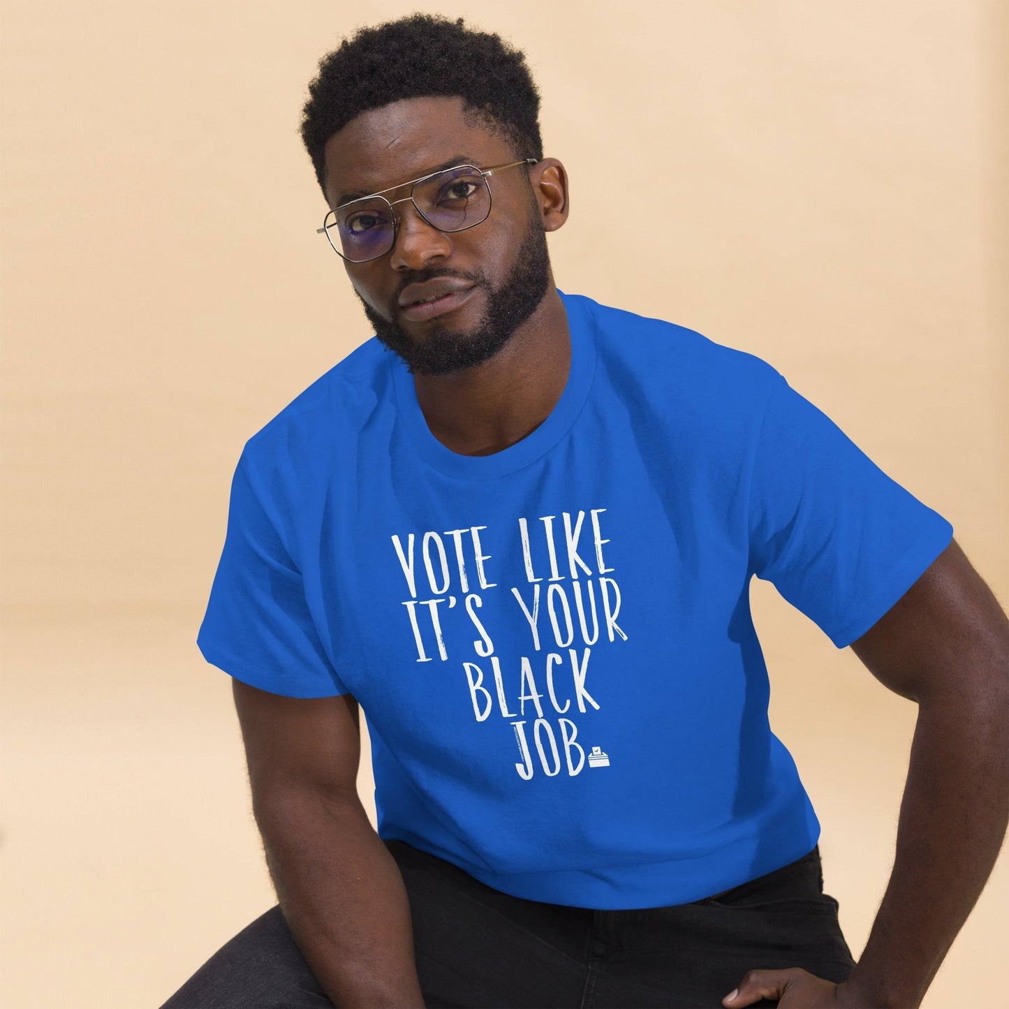 a man wearing a blue shirt with a black job written on it