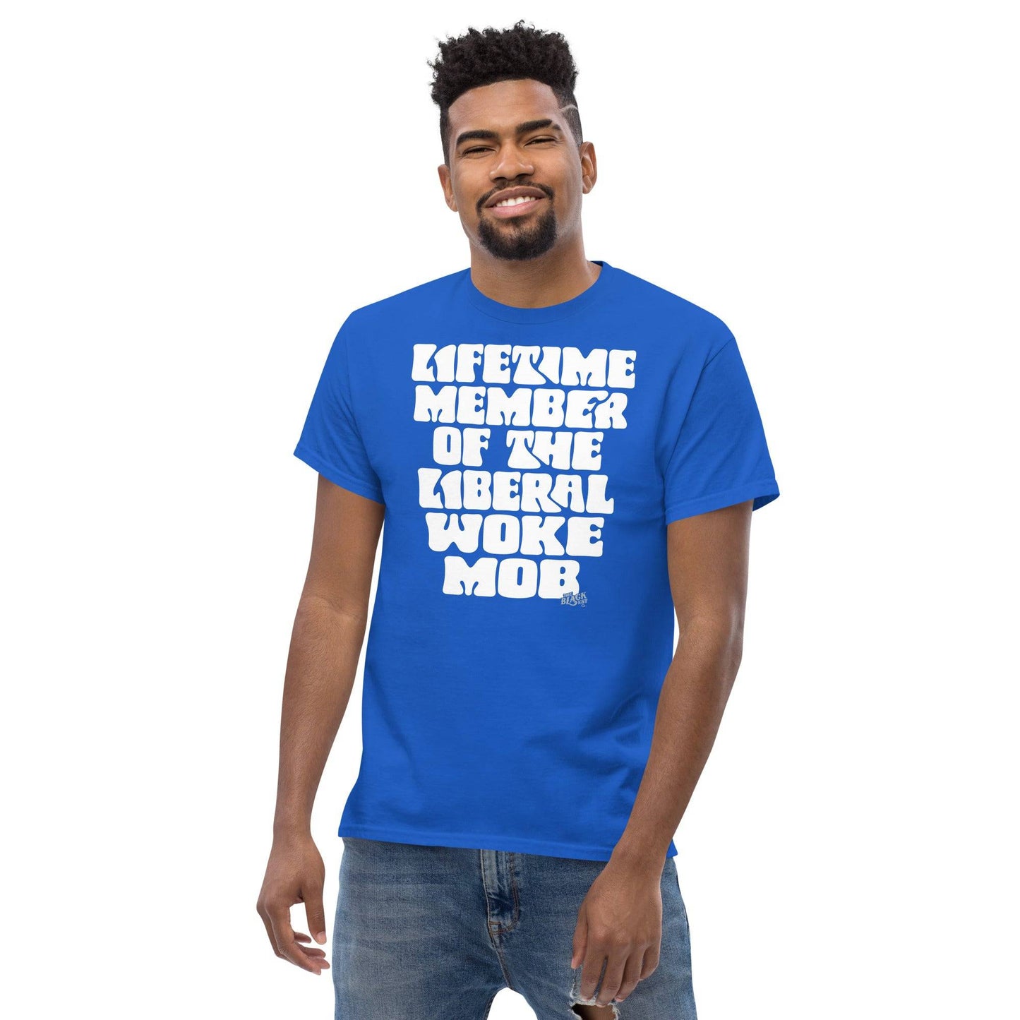 Man wearing a blue unisex t-shirt with bold white text 'Lifetime Member Of The Liberal Woke Mob,' styled casually with jeans.