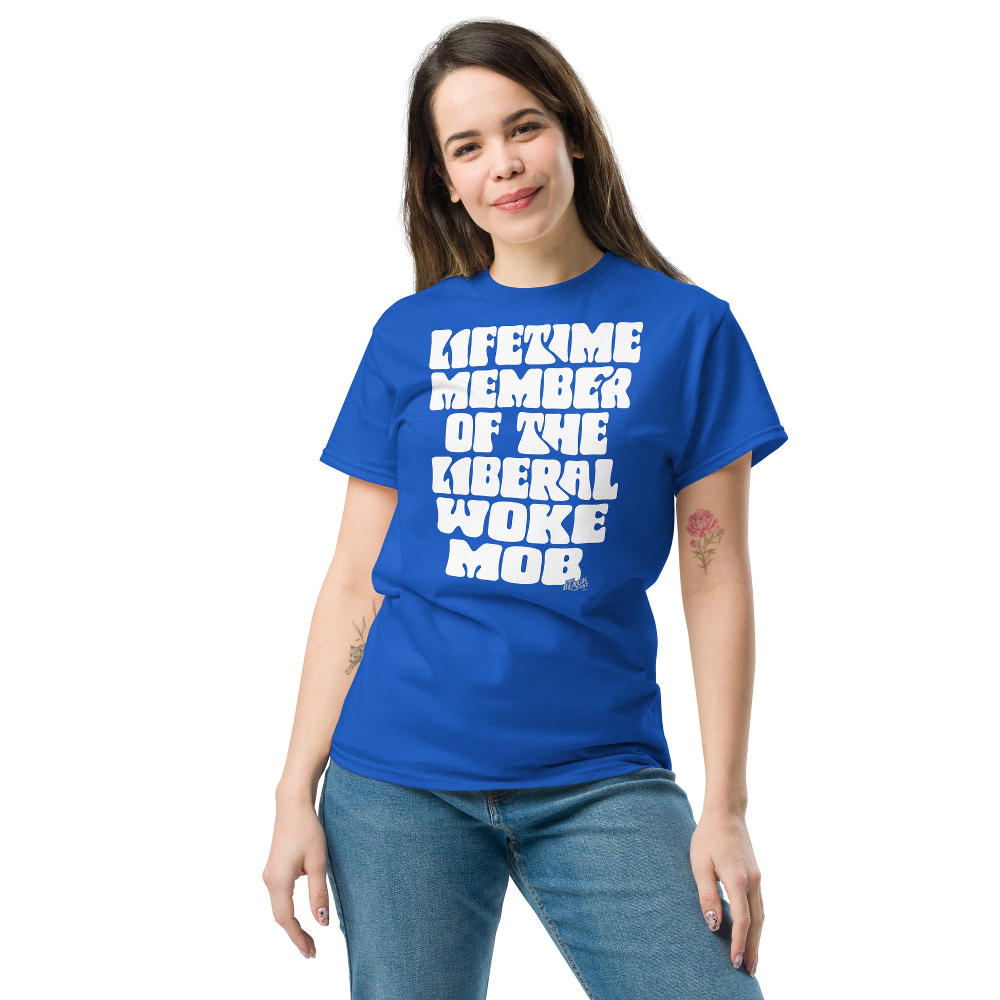 Woman modeling a blue unisex t-shirt with bold white text 'Lifetime Member Of The Liberal Woke Mob,' paired with denim jeans.