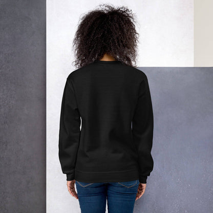 a woman standing in front of a wall wearing a black sweatshirt