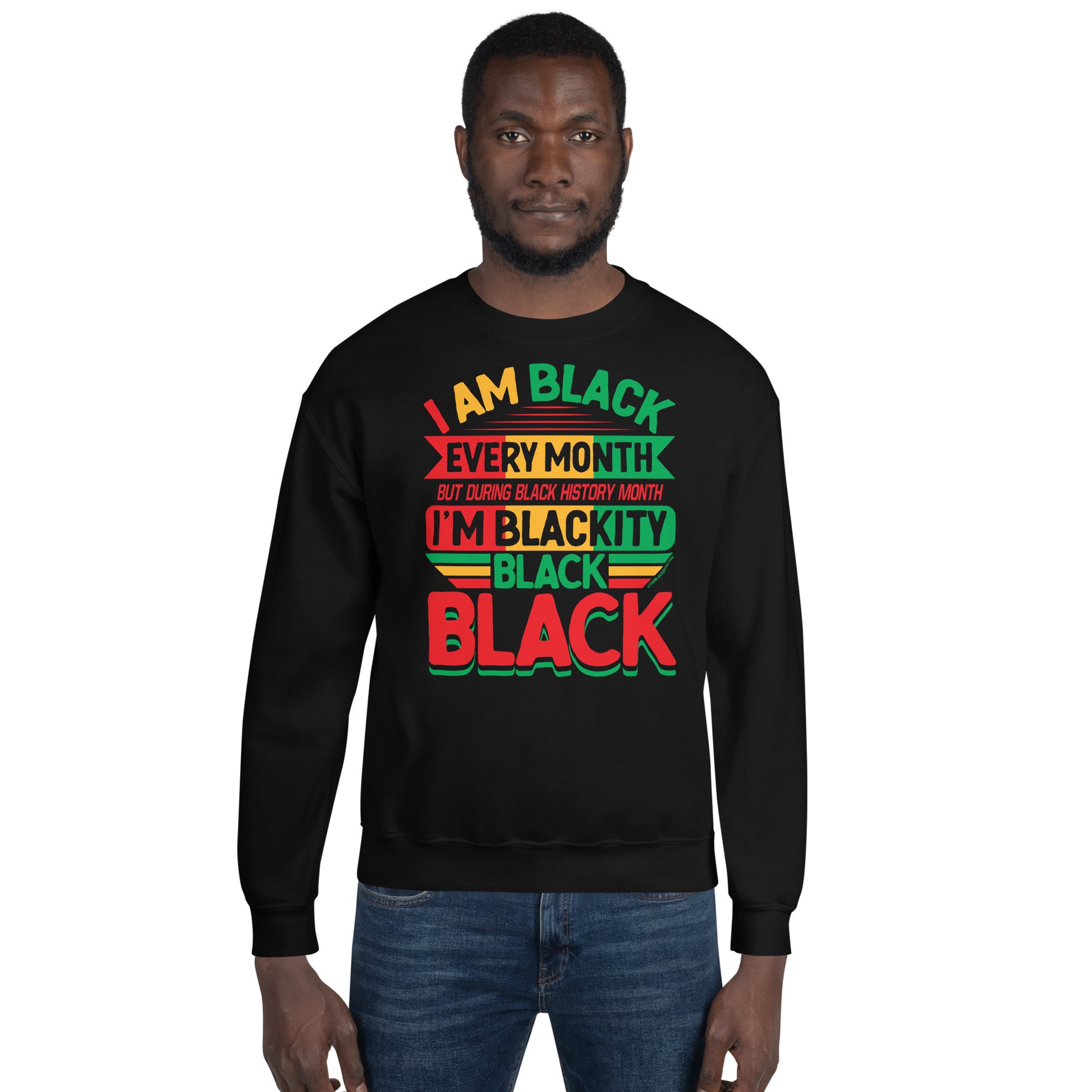 Model wearing the Blackity Black Black History Month Sweatshirt by TheBlackest Co in black, featuring vibrant red, green, and yellow text.