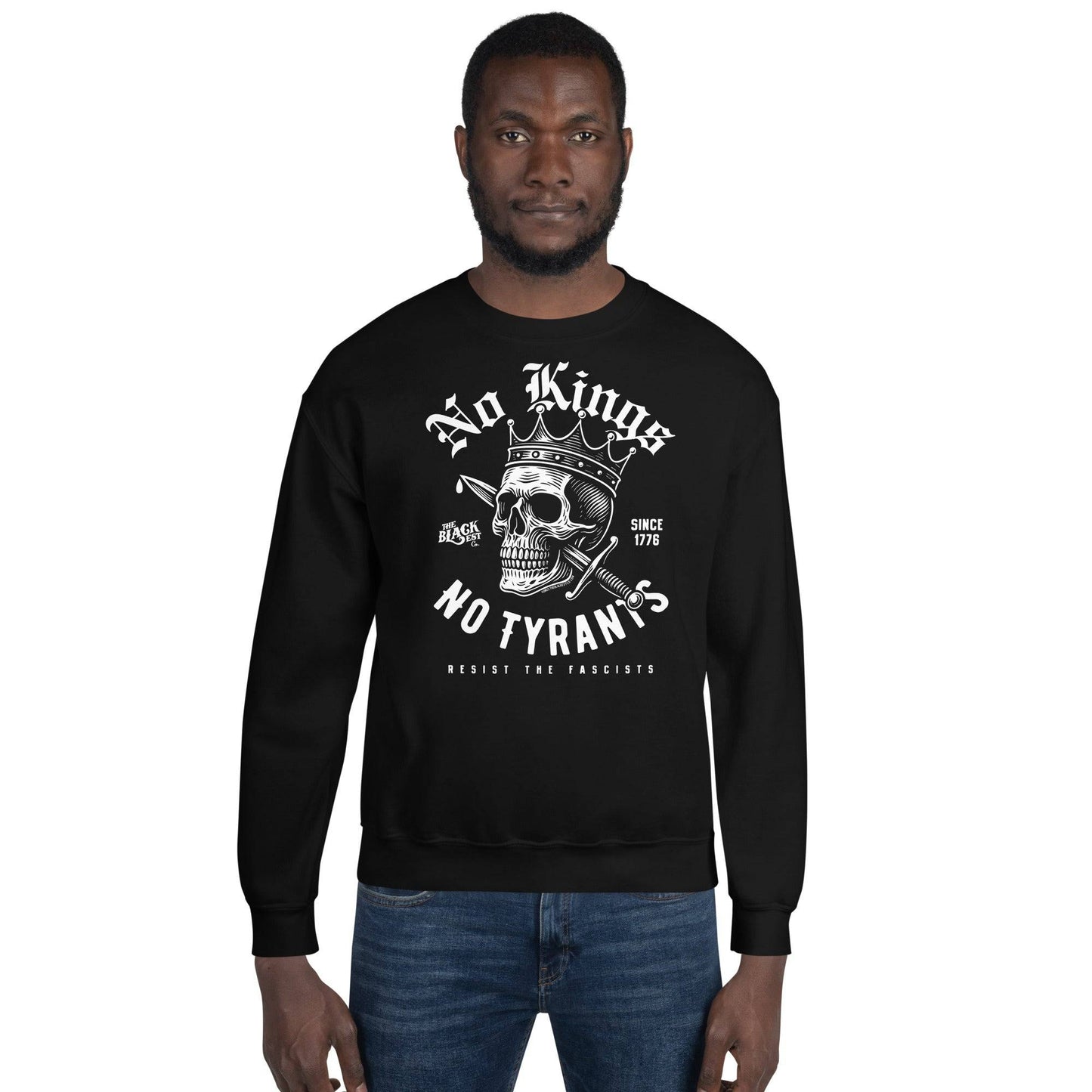 Man wearing No Kings No Tyrants Skull Protest Sweatshirt in black, showcasing bold resistance-themed streetwear by TheBlackest Co.