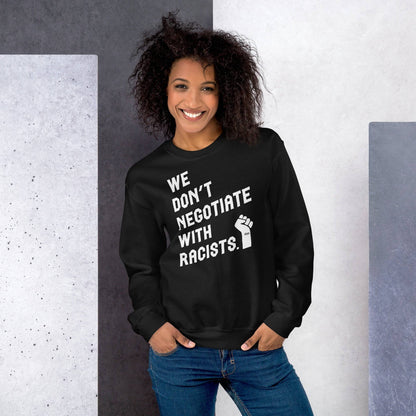 a woman wearing a black sweatshirt that says we don't negotiate with racists