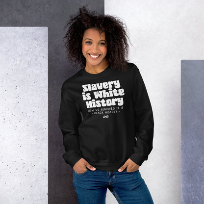 Woman posing in a black 'Slavery Is White History' sweatshirt by TheBlackest Co., styled with jeans, against a textured gray and white background.